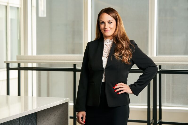 Chicago injury attorney, Jennifer L. Ashley, standing in the office of Salvi, Schostok & Pritchard