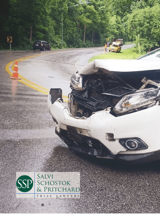 branded image with car wreck on wet country roadway