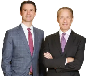 Experienced birth injury lawyers in professional suits, standing confidently and ready to advocate for families affected by medical negligence.